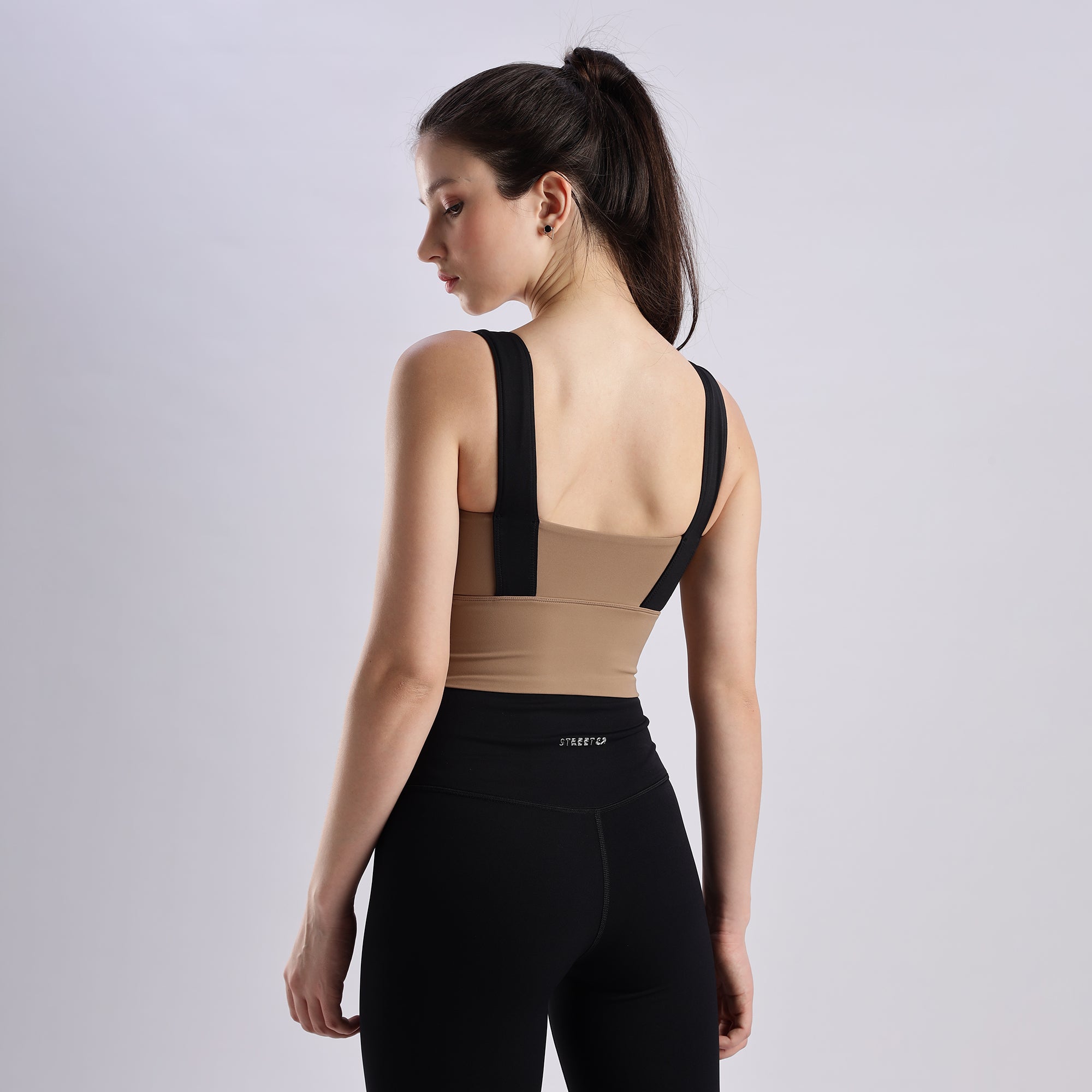 Woman wearing a Evoke Sports Braand black leggings.