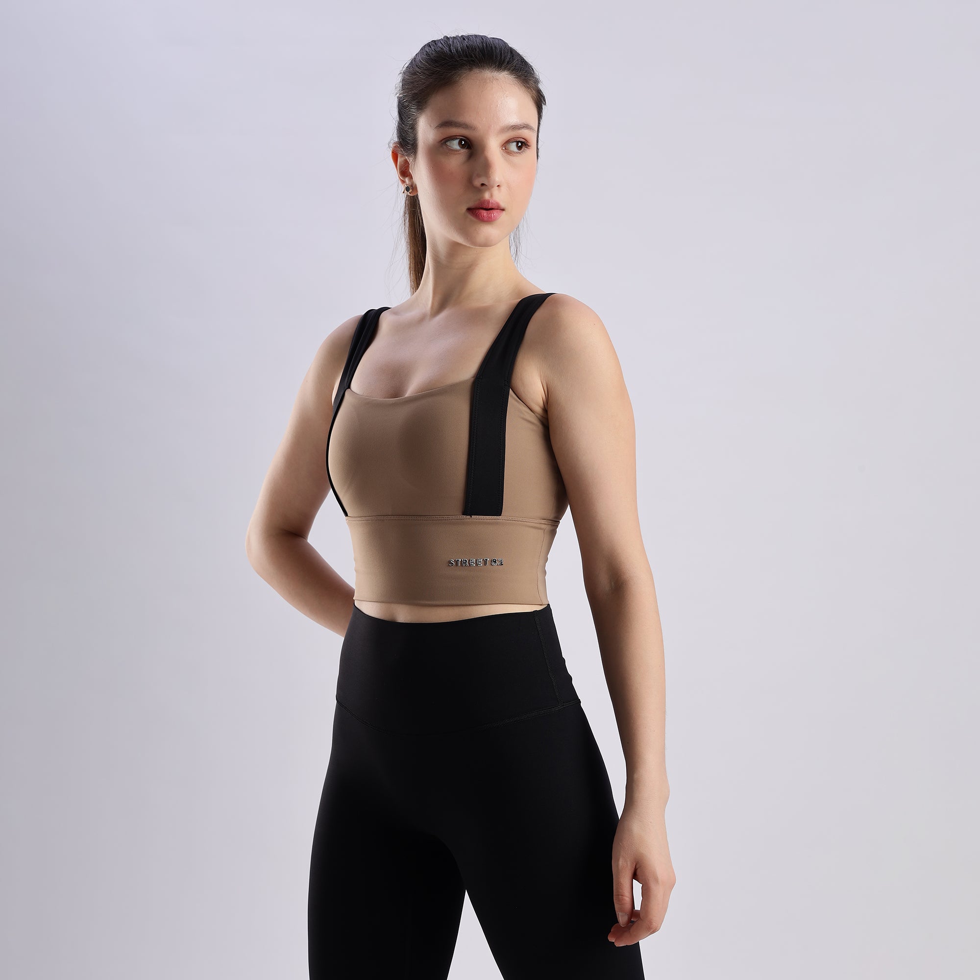 Woman wearing Evoke Sports Bra and black leggings.