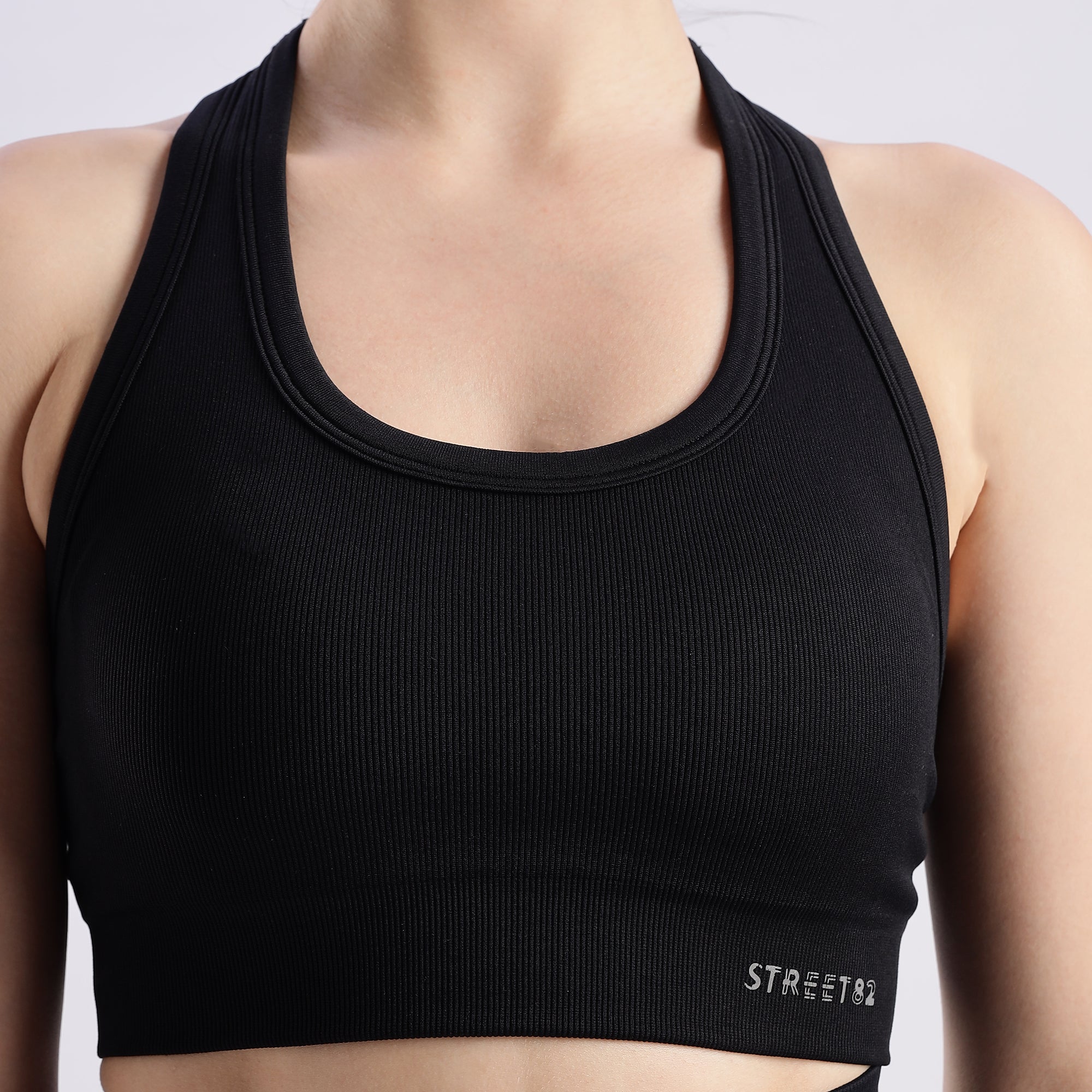 Black colour variant Pulse sports bra with a crew neckline featuring the brand name 'STREET82' on the front