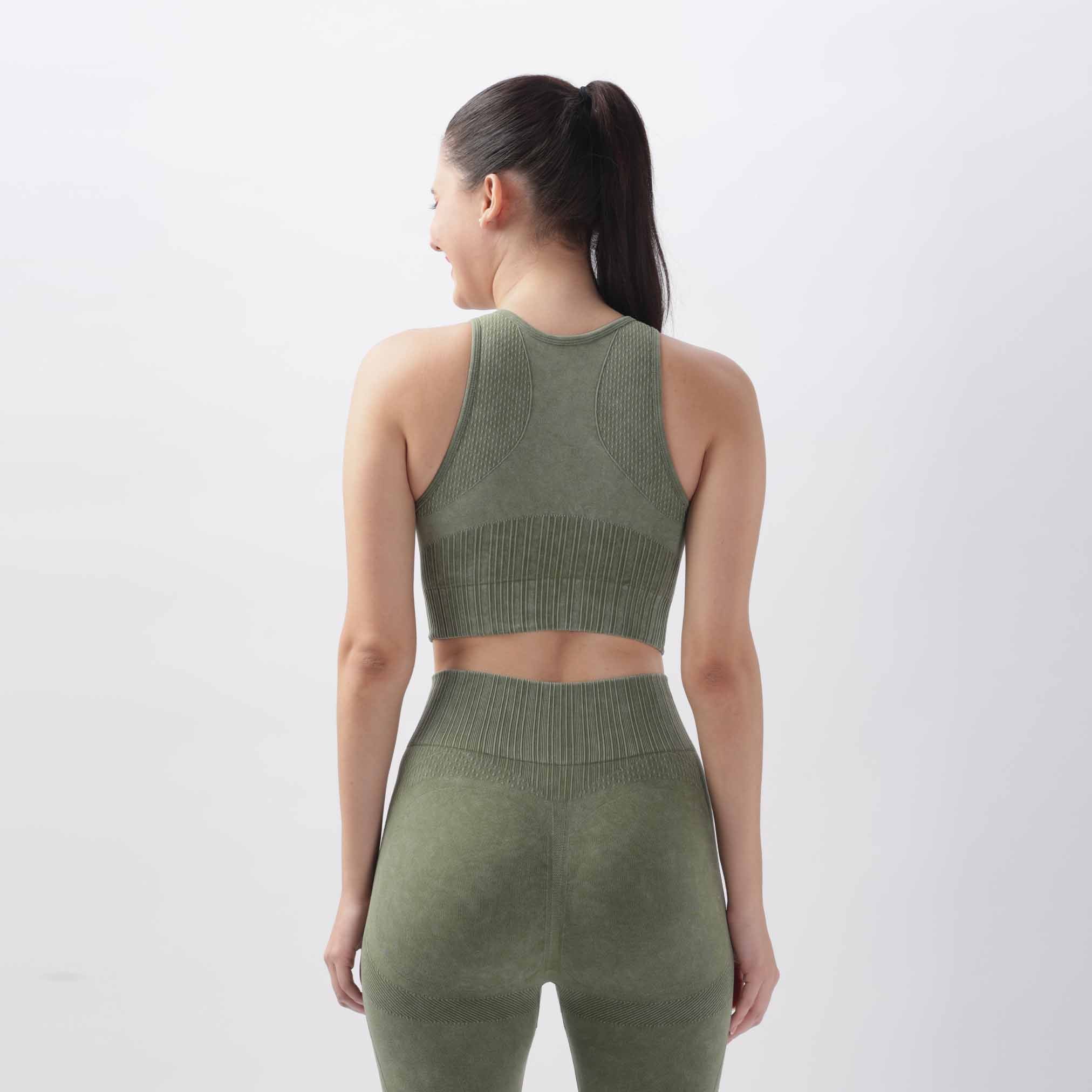Back view of A woman wearing a olive green knitted push-up sports bra fitness vest with a legging
