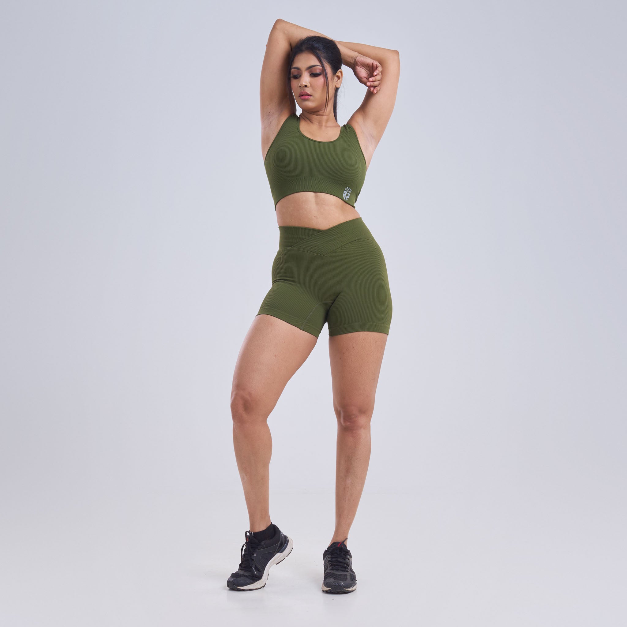 This image features a stylish and functional ladies sports bra in a vibrant green color. The sports bra is crafted from a blend of nylon and spandex, providing both breathability and stretch for comfort during athletic activities.